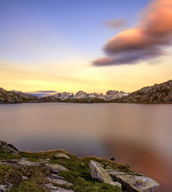 Scenic view of mountains against sky at sunset