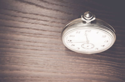 High angle close-up of clock on table