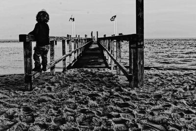 Man standing on beach against sky