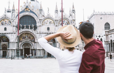 Young couple looking at cathedral in city