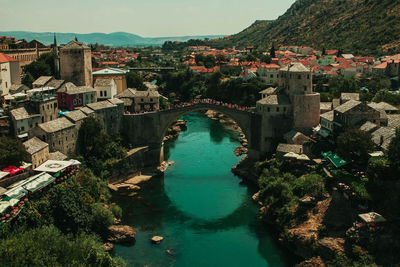 High angle view of river amidst buildings in town