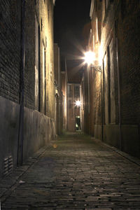 Empty walkway in illuminated building