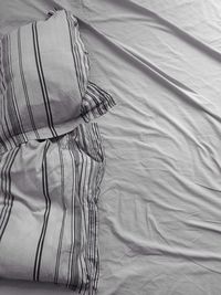 Unmade bed with white sheets