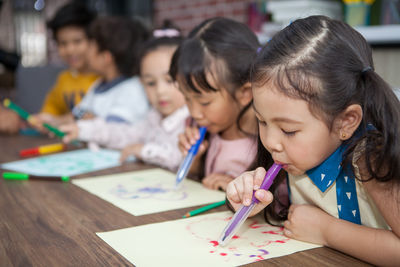 Girl with friends in classroom