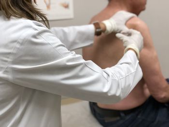 Man getting a steroid injection in shoulder for rotator cuff pain