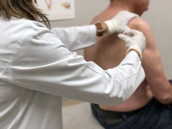 Man getting a steroid injection in shoulder for rotator cuff pain