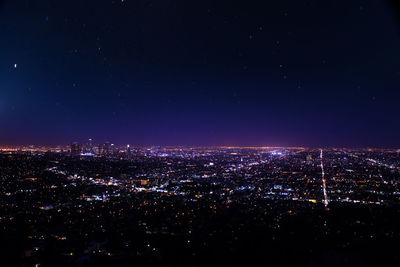 High angle view of illuminated buildings against sky at night