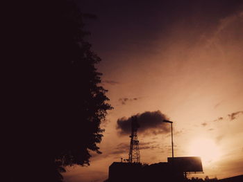 Low angle view of silhouette trees against sky at sunset