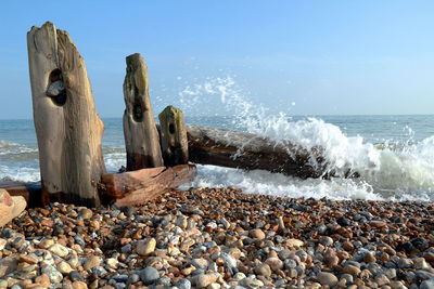 Rocks on beach against sky