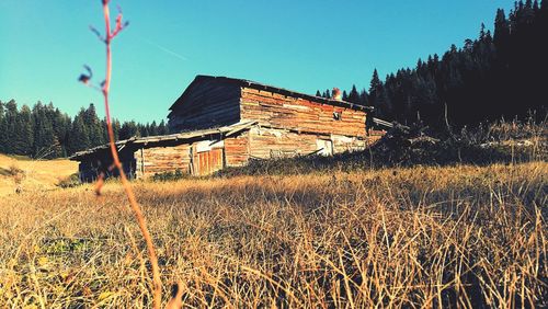 Panoramic shot of cottage on field against sky