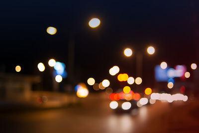 Defocused image of illuminated street lights at night