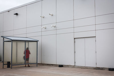 Rear view of woman walking by door