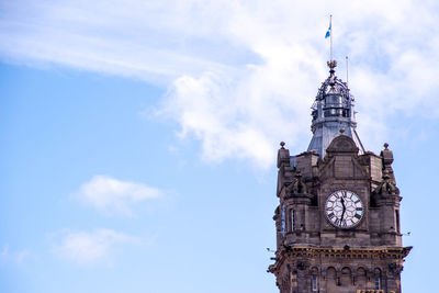 Low angle view of clock tower against sky in city