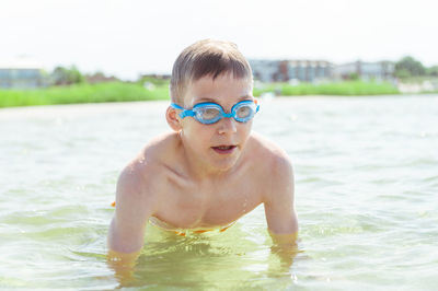 Portrait of shirtless boy in swimming pool