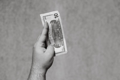 Cropped hand of woman using mobile phone