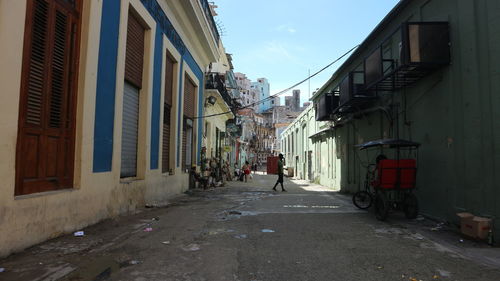 Man walking on street amidst buildings in city