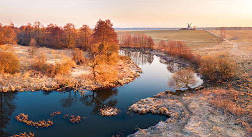 Reflection of trees in lake against sky during autumn