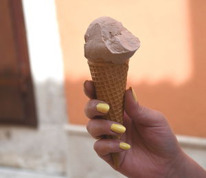 Close-up of hand holding ice cream cone