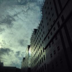 Low angle view of building against cloudy sky