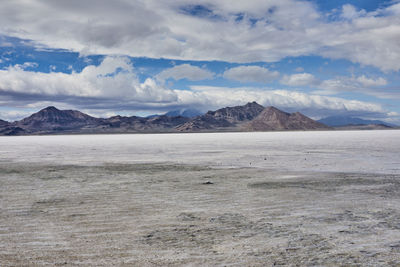 View of desert against cloudy sky