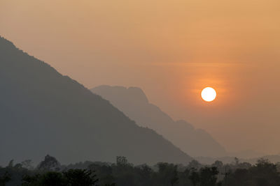 Scenic view of silhouette mountains against sky during sunset