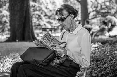 Midsection of woman sitting outdoors