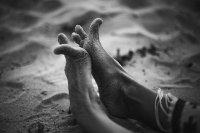 Close up funny feet on sandy beach monochrome concept photo