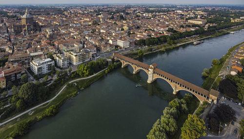 Classic aerial view of pavia, italy, in the afternoon. the dome and the old bridge on ticino river