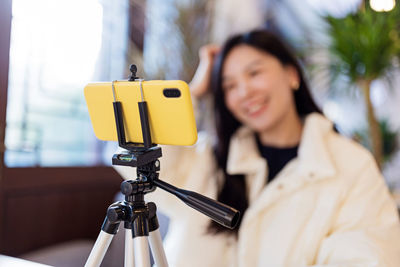 Defocused image of woman vlogging