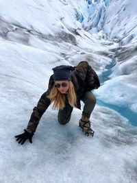 Woman climbing on glacier 