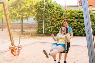 Young woman sitting on swing