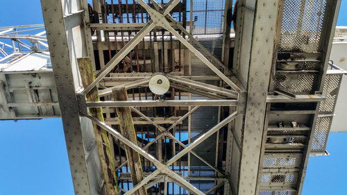 Low angle view of ferris wheel against buildings