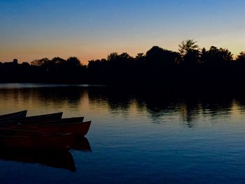 Scenic shot of calm lake at sunset