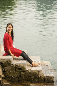 Beautiful woman sitting next to the river li in yangshuo