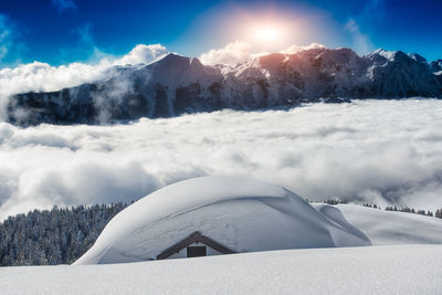 Scenic view of snow covered mountains against sky during sunset