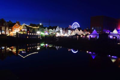 Reflection of illuminated buildings in water at night