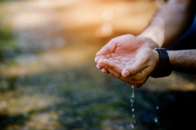 Close-up of hand touching water