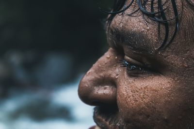 Close-up of smiling wet young man