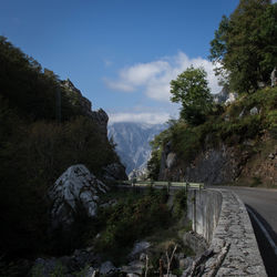 Scenic view of river by mountains against sky