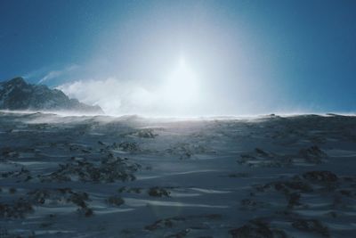 Scenic view of snow covered landscape against clear sky