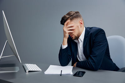 Side view of businesswoman working at desk in office