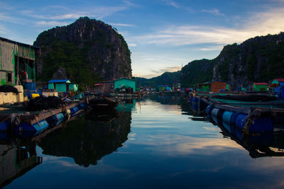 Boats moored in bay against sky