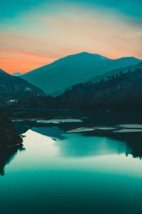 Scenic view of lake against sky during sunset