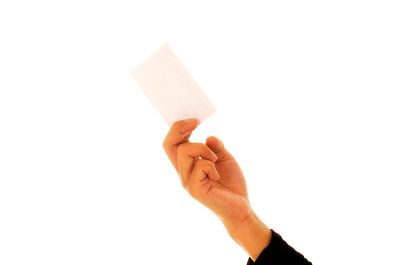Close-up of hand holding paper against white background