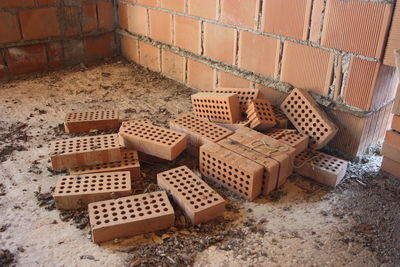 A stack of red bricks to build a residential house within the structure