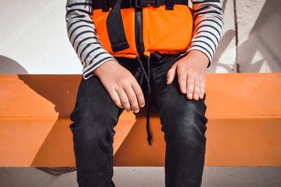 Low section of boy sitting in boat 