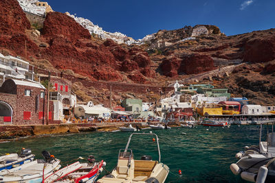 Boats in sea against mountain