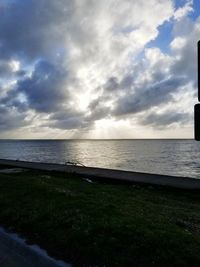 Scenic view of sea against cloudy sky