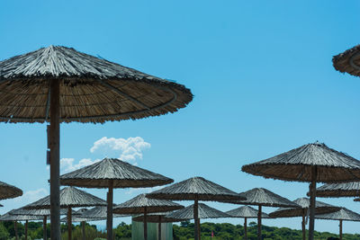 Built structure on beach against clear blue sky