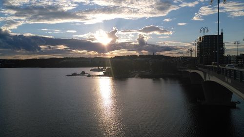 Sunset over river with buildings in background